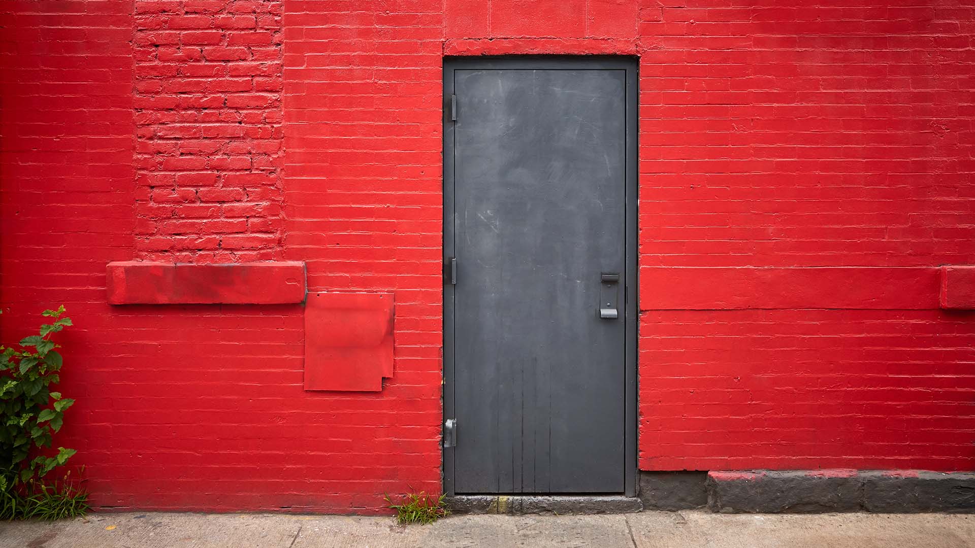 Steel door in an old red brick wall
